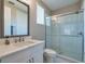 The bathroom has tile floors, white cabinets with a marble countertop, and a glass door shower stall at 3122 Christophers Watch Ln, Ruskin, FL 33570