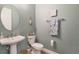 Modern half bathroom featuring a stylish sink, wall decor, and modern finishes at 3122 Christophers Watch Ln, Ruskin, FL 33570