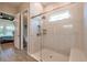Walk-in shower featuring stylish tile, glass enclosure, and views into the bedroom at 3122 Christophers Watch Ln, Ruskin, FL 33570