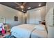 A cozy bedroom with a dark ceiling, ceiling fan, closet and white furniture at 3122 Christophers Watch Ln, Ruskin, FL 33570