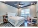 A cozy bedroom with a dark ceiling, ceiling fan, window, and white furniture at 3122 Christophers Watch Ln, Ruskin, FL 33570