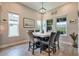 Charming dining room with large windows and modern chandelier provides plenty of light at 3122 Christophers Watch Ln, Ruskin, FL 33570