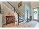 Inviting entryway with wooden floors, staircase, and decorative furnishings at 3122 Christophers Watch Ln, Ruskin, FL 33570