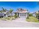 Beautiful two-story home with lush landscaping, paver driveway, and a two-car garage at 3122 Christophers Watch Ln, Ruskin, FL 33570