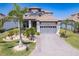 Beautiful two-story home with a two-car garage, tile roof, and lush landscaping at 3122 Christophers Watch Ln, Ruskin, FL 33570