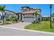 Beautiful two-story home with tropical landscaping, brick paver driveway, and a two-car garage at 3122 Christophers Watch Ln, Ruskin, FL 33570