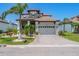 Beautiful two-story home with a two car garage, paver driveway, tropical landscaping, and a tile roof at 3122 Christophers Watch Ln, Ruskin, FL 33570