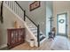 Inviting foyer with wood-look tile floors, staircase, and coat rack at 3122 Christophers Watch Ln, Ruskin, FL 33570