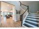 Inviting foyer with staircase leading to the second floor, and view into the living room at 3122 Christophers Watch Ln, Ruskin, FL 33570