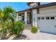 Inviting home featuring a charming front entrance and well-maintained landscaping at 3122 Christophers Watch Ln, Ruskin, FL 33570