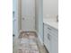 Hallway with white cabinets, gray countertops, and a colorful area rug at 3122 Christophers Watch Ln, Ruskin, FL 33570