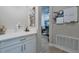 Hallway with white countertops, lower cabinets, and light gray walls at 3122 Christophers Watch Ln, Ruskin, FL 33570