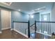 Upstairs hallway with dark wood floors, white railings, and recessed lighting at 3122 Christophers Watch Ln, Ruskin, FL 33570