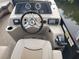 Pontoon boat helm featuring a modern control panel, comfortable seating, and easy-to-read instruments for a smooth ride at 3122 Christophers Watch Ln, Ruskin, FL 33570