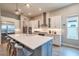 Bright kitchen features stainless steel appliances, large island, and walk-in pantry at 3122 Christophers Watch Ln, Ruskin, FL 33570