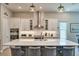 Well-lit kitchen with white cabinets, a kitchen island, and modern pendant lights at 3122 Christophers Watch Ln, Ruskin, FL 33570
