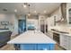 Modern kitchen with stainless steel appliances, large island, and stylish lighting at 3122 Christophers Watch Ln, Ruskin, FL 33570