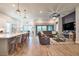 Open concept: Kitchen island faces large living space with hardwood floors and neutral colors at 3122 Christophers Watch Ln, Ruskin, FL 33570