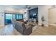 Living room featuring hardwood floors and a large sectional sofa. Sliding doors to balcony at 3122 Christophers Watch Ln, Ruskin, FL 33570