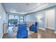 Living room with modern furniture, a large area rug, and sliding glass doors to a balcony at 3122 Christophers Watch Ln, Ruskin, FL 33570