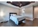 This main bedroom boasts hardwood floors, a ceiling fan, and tray ceiling with recessed lighting at 3122 Christophers Watch Ln, Ruskin, FL 33570