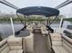 Spacious pontoon boat featuring ample seating, a shade canopy, and a clear view, ideal for entertaining guests at 3122 Christophers Watch Ln, Ruskin, FL 33570