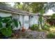 Backyard with an exterior view of the home's washer and dryer and lush greenery at 3212 56Th N Ave, St Petersburg, FL 33714