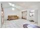 Open living area with tile flooring, couch, and bright natural light at 3212 56Th N Ave, St Petersburg, FL 33714