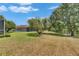 Large backyard with view of the pond and screened-in lanai at 3333 Michener Pl, Plant City, FL 33566