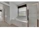Bathroom with large tub, glass shower, and window with blind at 3333 Michener Pl, Plant City, FL 33566