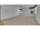 Spacious bedroom with neutral carpet, ceiling fan, and natural light from two windows at 3333 Michener Pl, Plant City, FL 33566