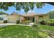 Inviting single-story home featuring a green front door, attached garage, and lush green lawn at 3333 Michener Pl, Plant City, FL 33566