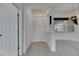 Bright foyer with tile flooring leading into a carpeted living area, showcasing an elegant chandelier at 3333 Michener Pl, Plant City, FL 33566