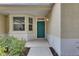 A welcoming front porch featuring a bay window and a vibrant green front door at 3333 Michener Pl, Plant City, FL 33566