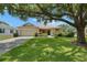 Charming single-story home with a well-manicured lawn and mature trees providing shade at 3333 Michener Pl, Plant City, FL 33566
