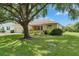Single-story home with an attached garage, well-kept lawn, and mature trees enhancing the curb appeal at 3333 Michener Pl, Plant City, FL 33566