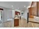 Kitchen with tile flooring, breakfast bar, stainless appliances, and brown cabinetry at 3333 Michener Pl, Plant City, FL 33566