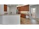 Kitchen with tile flooring, breakfast bar, stainless appliances, and brown cabinetry at 3333 Michener Pl, Plant City, FL 33566