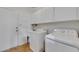 Bright laundry room with a washer, dryer, sink, and white cabinets for storage at 3333 Michener Pl, Plant City, FL 33566