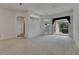 Open living room featuring neutral carpeting, with a view of the screened patio at 3333 Michener Pl, Plant City, FL 33566