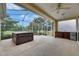 Screened-in patio featuring a hot tub and an outdoor kitchen area with a sink and mini-fridge at 3333 Michener Pl, Plant City, FL 33566