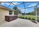 Relaxing screened-in patio featuring a hot tub and serene outdoor views at 3333 Michener Pl, Plant City, FL 33566