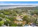 An aerial view of a home surrounded by lush greenery, situated in a neighborhood close to a tranquil body of water at 3417 1St W Ave, Bradenton, FL 34205