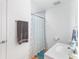 This bathroom features a shower, a towel rack with a towel, a vanity and a blue rug at 3417 1St W Ave, Bradenton, FL 34205