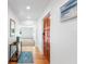 Bright entryway with hardwood floors, a console table, and a view to the spacious living area at 3417 1St W Ave, Bradenton, FL 34205
