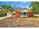 Charming single-story brick home with a bay window, landscaped yard, and palm tree at 3417 1St W Ave, Bradenton, FL 34205