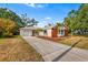 Charming single-story home with a well-manicured lawn and a long driveway to an attached garage at 3417 1St W Ave, Bradenton, FL 34205