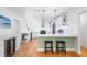 Bright kitchen features stainless steel appliances, white cabinets, light countertops and a center island with stools at 3417 1St W Ave, Bradenton, FL 34205
