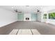 Spacious living room featuring a fireplace, large windows, and neutral carpeting at 3417 1St W Ave, Bradenton, FL 34205