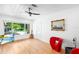 Living room with modern furniture, hardwood floors, large window and view of yard at 3417 1St W Ave, Bradenton, FL 34205